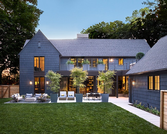 custom built gray house exterior and backyard